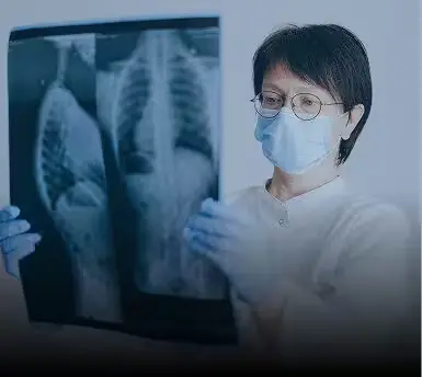 Doctor reviewing a chest X-ray after a serious injury